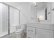 Bright bathroom featuring white vanity, marble countertop, and a glass-enclosed shower with bench seating at 5625 W 141St Ln, Broomfield, CO 80020