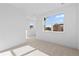Bright bedroom features large windows and neutral carpeting providing a calm, airy feel at 5625 W 141St Ln, Broomfield, CO 80020