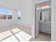 Bright bedroom with a window, adjacent bathroom, and neutral carpet offers a modern feel at 5625 W 141St Ln, Broomfield, CO 80020