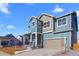 Attractive blue two-story home with a front porch, a two-car garage, and manicured landscaping at 5625 W 141St Ln, Broomfield, CO 80020