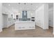 Modern kitchen features white cabinets, tile backsplash, a center island and stainless steel appliances at 5625 W 141St Ln, Broomfield, CO 80020