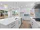 Spacious kitchen with white cabinets, stainless appliances, island with seating and ample counter space, overlooking the outdoor patio at 5625 W 141St Ln, Broomfield, CO 80020