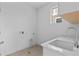 Well-lit laundry room featuring a deep sink with quartz countertops and plenty of space for appliances at 5625 W 141St Ln, Broomfield, CO 80020