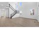 Spacious living room features high ceilings, a staircase, large windows, and luxury vinyl plank flooring at 5625 W 141St Ln, Broomfield, CO 80020