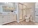 Main bathroom with double vanity and walk-in shower at 33100 Ridgeview Loop, Elizabeth, CO 80107