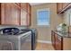 Laundry room with wood cabinets and granite countertop at 33100 Ridgeview Loop, Elizabeth, CO 80107