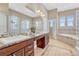 Ensuite bathroom with double vanity and a soaking tub at 33100 Ridgeview Loop, Elizabeth, CO 80107