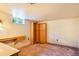 Unfinished basement with built in desk and shelving at 4730 Pierce St, Wheat Ridge, CO 80033