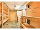 Unfinished basement area with shelving, workbench, utility sink, and washer/dryer hookups, ready for customization at 4730 Pierce St, Wheat Ridge, CO 80033