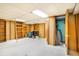 Spacious basement area features carpet flooring, shelving, and ample room for storage or recreation at 4730 Pierce St, Wheat Ridge, CO 80033