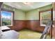 Green Bedroom offers natural light with two windows. Features paneled wall and retro green carpet at 4730 Pierce St, Wheat Ridge, CO 80033