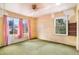 Bedroom with two windows and outdated carpet in a home that needs updating at 4730 Pierce St, Wheat Ridge, CO 80033