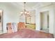 Dining room featuring vintage chandelier, doorway access and salmon colored floor tile at 4730 Pierce St, Wheat Ridge, CO 80033