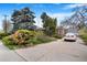 Exterior view of home with a car parked on a driveway leading to a detached garage at 4730 Pierce St, Wheat Ridge, CO 80033
