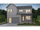 Charming two-story home featuring gray siding, a two-car garage, and a welcoming front entrance with a light-brick facade at 1287 Stillspring Ln, Castle Pines, CO 80108