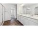Bathroom featuring double sinks, granite counters, and walk in shower at 45934 Gentry Ave, Bennett, CO 80102