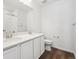 Modern bathroom with double sinks, granite counters, and white cabinetry at 45934 Gentry Ave, Bennett, CO 80102
