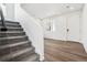 Bright entryway featuring modern vinyl floors and a carpeted staircase leading to the upper level at 45934 Gentry Ave, Bennett, CO 80102