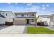 Charming two-story home featuring manicured lawn, stone accents, and a spacious two-car garage at 45934 Gentry Ave, Bennett, CO 80102