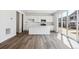 Modern kitchen featuring white cabinets, a center island, and sliding glass doors to the backyard at 45934 Gentry Ave, Bennett, CO 80102