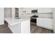 Contemporary kitchen with stainless steel appliances, quartz countertops, and a center island at 45934 Gentry Ave, Bennett, CO 80102