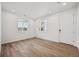 Sunlit living room featuring modern vinyl floors, white walls, and ample natural light at 45934 Gentry Ave, Bennett, CO 80102