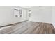 Spacious living room showcasing modern vinyl floors and abundant natural light from the windows at 45934 Gentry Ave, Bennett, CO 80102