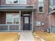 Townhome entry with a black door and gray porch at 6561 N Malaya St, Aurora, CO 80019