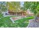 Beautifully landscaped backyard with a multi-level deck, stone accents, and lush green lawn at 13723 Milwaukee Ct, Thornton, CO 80602