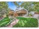 Expansive backyard featuring a multi-tiered wooden deck, stone landscaping, and access to the home at 13723 Milwaukee Ct, Thornton, CO 80602
