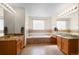 Bright bathroom featuring granite countertops, tile flooring, and a soaking tub at 13723 Milwaukee Ct, Thornton, CO 80602