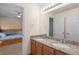 Bathroom showcasing granite countertops, double sinks, and a connection to a bedroom at 13723 Milwaukee Ct, Thornton, CO 80602
