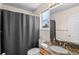 Bathroom featuring a sink with granite countertop and a shower-tub combination at 13723 Milwaukee Ct, Thornton, CO 80602