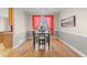 Well-lit dining room features hardwood floors, classic trimwork and ample space for entertaining at 13723 Milwaukee Ct, Thornton, CO 80602