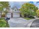 Charming two-story home with a three-car garage, brick accents, a large yard, and mature trees at 13723 Milwaukee Ct, Thornton, CO 80602