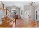Spacious foyer with hardwood floors, staircase, and chandelier at 13723 Milwaukee Ct, Thornton, CO 80602
