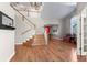 Bright foyer featuring hardwood floors, staircase, chandelier, and large arched window at 13723 Milwaukee Ct, Thornton, CO 80602
