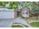 Inviting front entrance with brick accents, a decorative door, and landscaping at 13723 Milwaukee Ct, Thornton, CO 80602