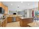 Updated kitchen features a center island, granite countertops and stainless steel appliances at 13723 Milwaukee Ct, Thornton, CO 80602