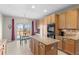 This bright kitchen features granite countertops, a central island and access to the outdoor deck at 13723 Milwaukee Ct, Thornton, CO 80602