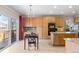 Bright eat-in kitchen features wood cabinetry, granite countertops and stainless steel appliances at 13723 Milwaukee Ct, Thornton, CO 80602