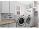 Well-organized laundry room with modern appliances, granite countertop, and ample storage space at 13723 Milwaukee Ct, Thornton, CO 80602