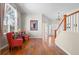 Inviting living room featuring hardwood floors, chandelier, and staircase at 13723 Milwaukee Ct, Thornton, CO 80602