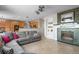 Open-concept living room with a fireplace, built-in shelving, and connection to the kitchen and dining area at 13723 Milwaukee Ct, Thornton, CO 80602