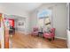 Open-concept living room featuring hardwood floors, and large arched window at 13723 Milwaukee Ct, Thornton, CO 80602