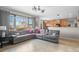 Bright living room featuring large windows, comfortable seating, and an open floor plan at 13723 Milwaukee Ct, Thornton, CO 80602