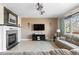 Cozy living room with a fireplace, large window, and comfortable seating at 13723 Milwaukee Ct, Thornton, CO 80602