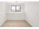 An empty bedroom featuring neutral carpet and a large window at 10024 Holland Ct, Broomfield, CO 80021