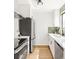 Modern kitchen offers stainless steel appliances, sleek white cabinetry, and tile backsplash at 10024 Holland Ct, Broomfield, CO 80021