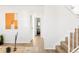 Bright living area featuring wood floors and an entry to a modern bathroom at 10024 Holland Ct, Broomfield, CO 80021